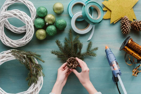 Partial view of woman making handmade christmas wreath on blue wooden surface — Stock Image Partial View Woman Making Handmade Christmas Wreath Blue Wooden Surface Stock Photo