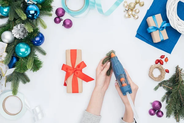 Partial view of woman decorating christmas present with pine tree branch isolated on white — Stock Image Partial View Woman Decorating Christmas Present Pine Tree Branch Isolated Stock Photo