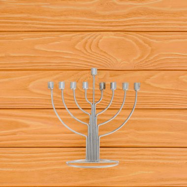 top view of menorah on wooden surface, hannukah holiday concept clipart