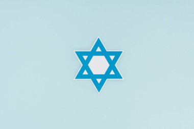 top view of traditional jewish star isolated on blue, hannukah holiday concept clipart