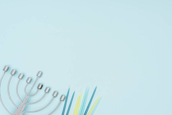top view of menorah and candles isolated on blue, hannukah celebration concept