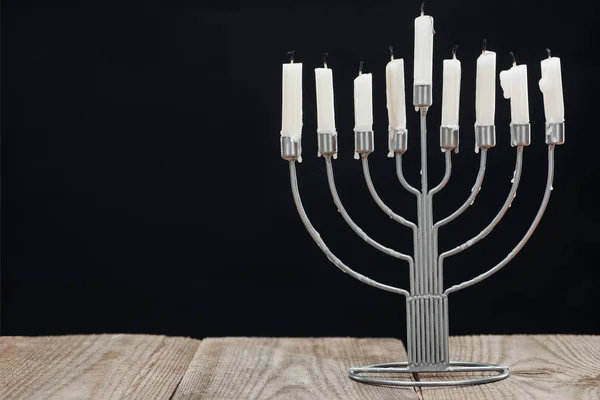 近观犹太灯台与蜡烛为光明节假日庆祝在木桌面查出的黑色 光明节概念 — 免费的图库照片