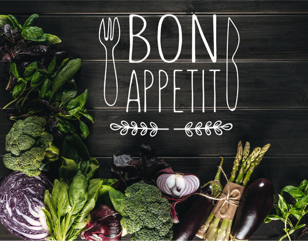 top view of different fresh vegetables on wooden tabletop with copy space, bon appetit lettering