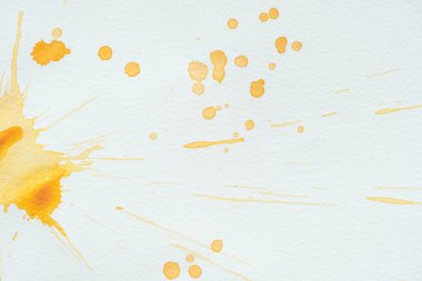 artistic orange watercolor splatters on white paper background clipart