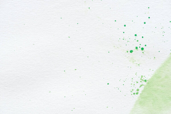 abstract green watercolor splatters on white paper background with copy space