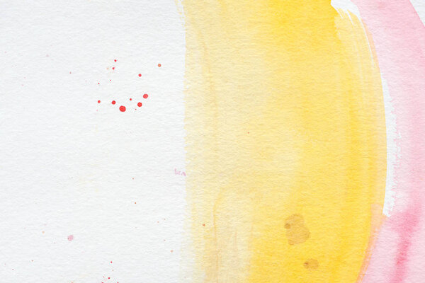 pink and yellow paint strokes with red splatters on white paper background