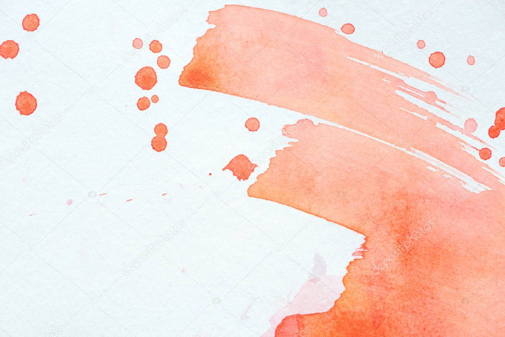 abstract red watercolor strokes and splatters on white paper