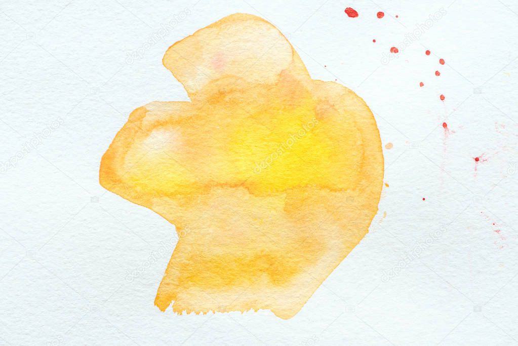 abstract orange and yellow watercolor painting on white paper