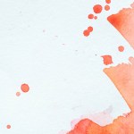 Creative background with red watercolor strokes and splatters on white paper