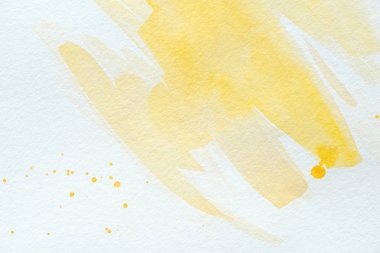 artistic yellow watercolor strokes on white paper clipart