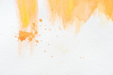 abstract orange watercolor painting with splatters on white paper clipart