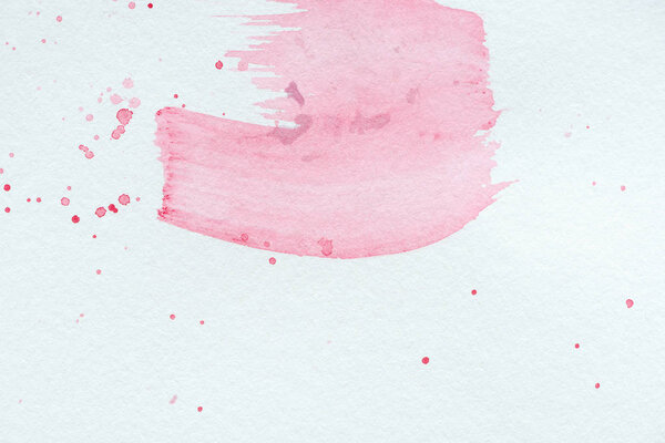 abstract background with light pink watercolor strokes and splatters