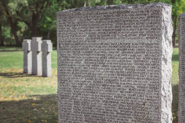 close up view of memorial tombstone with lettering at graveyard  clipart
