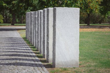 selective focus of stone tombs placed in row at graveyard clipart