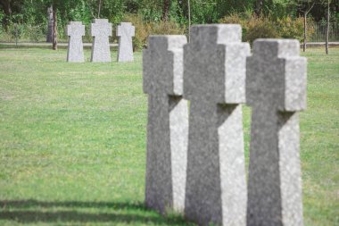 selective focus of cemetery with old memorial headstones placed in rows 