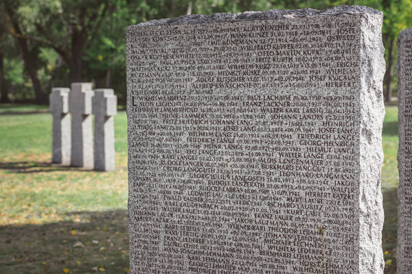 close up view of memorial tombstone with lettering at graveyard 