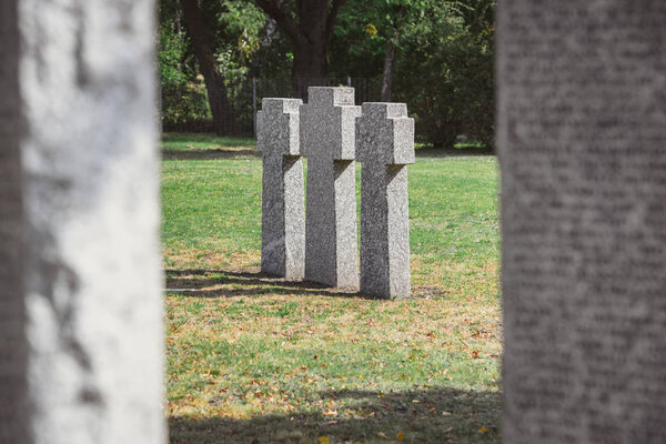selective focus of identical gravestones placed in row at graveyard