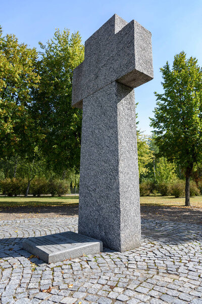 memorial headstone in shape of cross at cemetery 