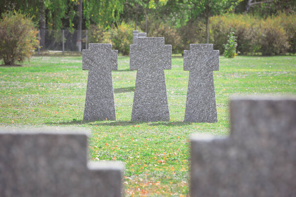 old gravestones placed in row on grass at graveyard 