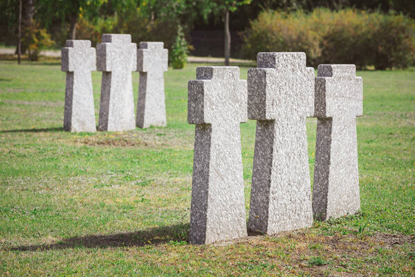 cemetery with identical old memorial headstones placed in rows 