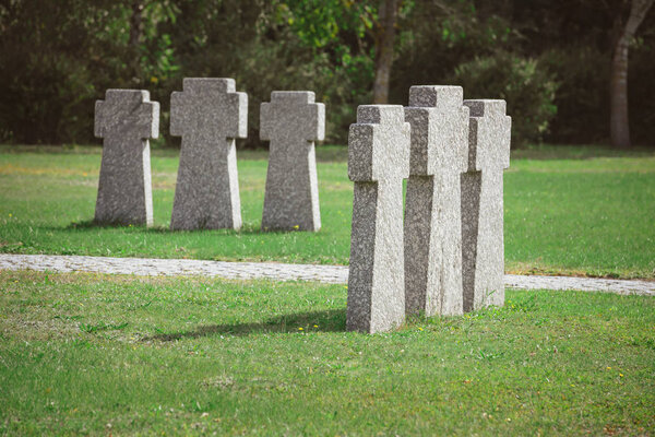 cemetery with identical old memorial headstones placed in rows 