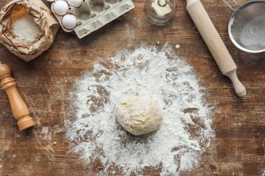 top view of uncooked formed dough on wooden table clipart
