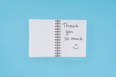 notebook with thank you so much lettering isolated on blue background clipart