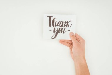 cropped view of person holding white postcard with thank you lettering isolated on white background