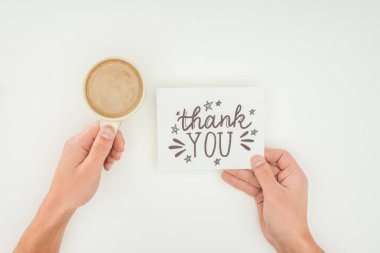 hands holding thank you lettering on white postcard and coffee isolated on white background clipart