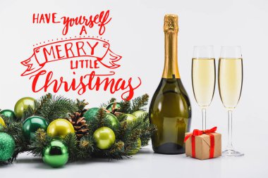 bottle and glasses of champagne, christmas wreath and gift on white background with 