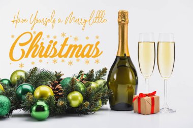 bottle and glasses of champagne, christmas wreath and gift on white background with 