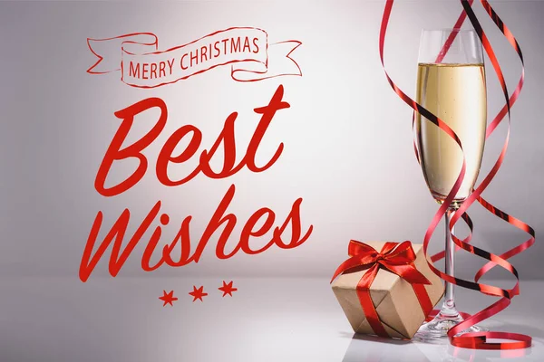 Glass Champagne Wrapped Gift Grey Backdrop Best Wishes Merry Christmas — Free Stock Photo