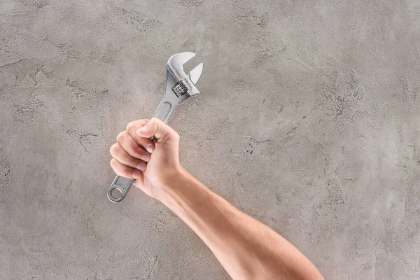 Cropped Shot Man Holding Pipe Wrench Concrete Tabletop — Stock Photo, Image