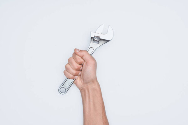 cropped shot of man holding adjustable wrench isolated on white