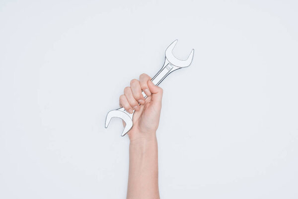 cropped shot of woman holding wrench isolated on white