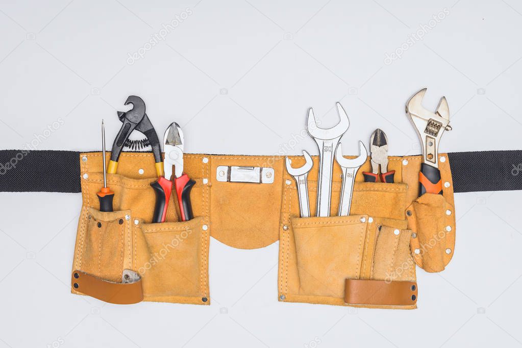 top view of tool kit belt with different repairman instruments isolated on white