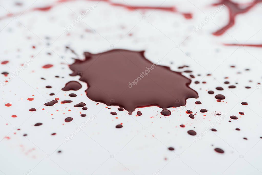 close-up shot of messy blood blot on white surface