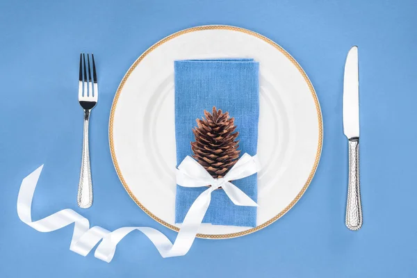Elevated View Plate Pine Cone Wrapped Festive Ribbon Fork Knife — Free Stock Photo