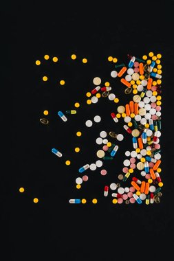 elevated view of pile colorful various pills isolated on black  clipart