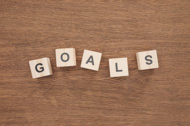 top view of 'goals' word made of wooden blocks on wooden tabletop, goal setting concept clipart