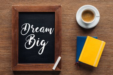 top view of chalk board with 'dream big' lettering on wooden background clipart