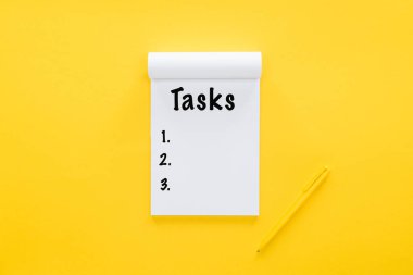 top view of notebook with tasks list on yellow clipart