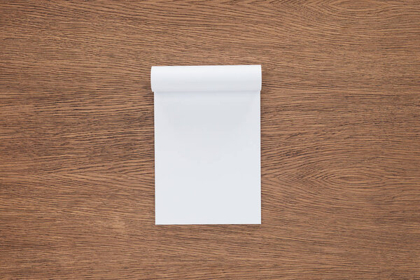 top view of blank notebook on wooden background
