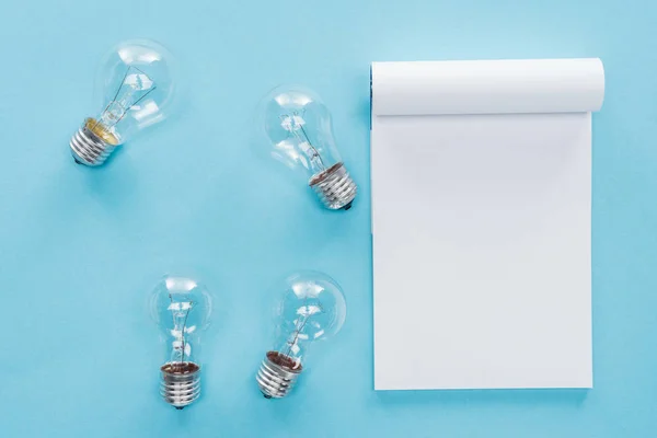 Top View Blank Notebook Light Bulbs Blue Background Having Idea — Stock Photo, Image