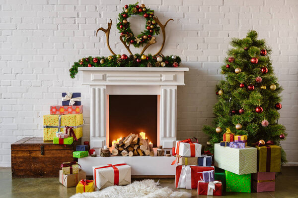 festive living room with cozy fireplace, christmas tree and presents