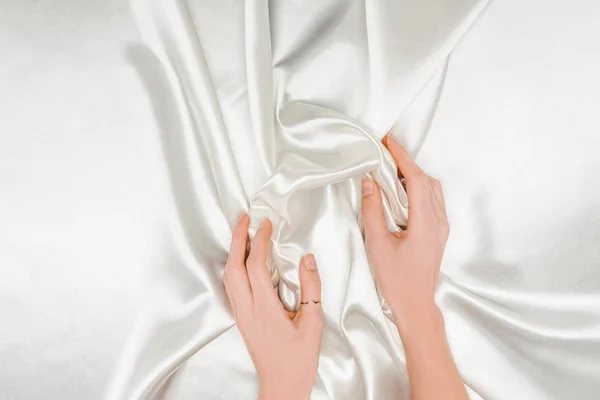 Bijgesneden Beeld Van Vrouwelijke Handen Zachtjes Met Witte Satijnen Doek — Gratis stockfoto