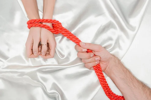 Cropped View Male Hand Bounding Female Hands Bright Red Rope — Stock Photo, Image