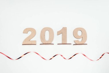 top view of 2019 date made of wooden numbers with curly ribbon isolated on white clipart