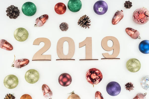 top view of 2019 date made of wooden numbers on background with christmas decorations isolated on white