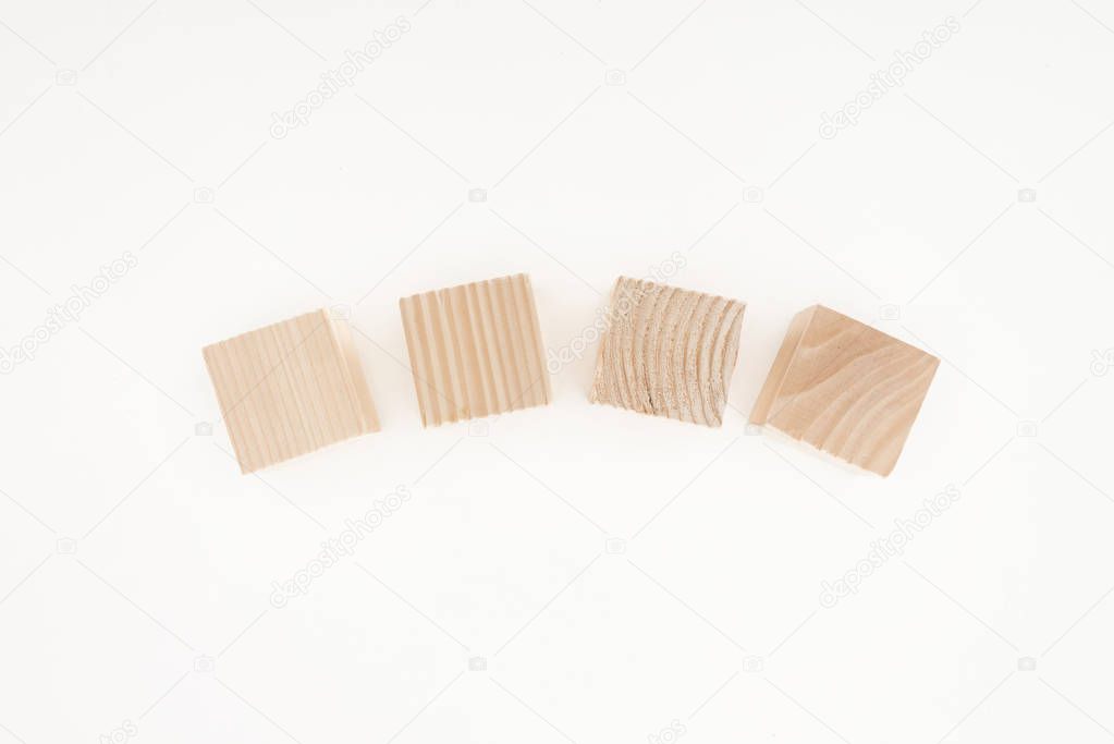 top view of four wooden blocks isolated on white